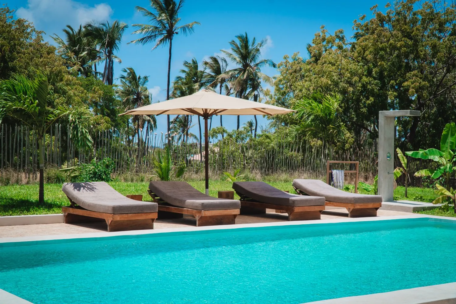 Sun loungers by the pool at Watamu Dunes